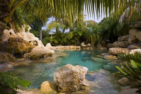 This custom lagoon pool by Lucas Lagoons included a white sand bottom with natural Florida limestone rocks and boulders set inside and outside the pool forming two multiple water features on opposite sides flowing into the pool.  Swimming under the water with the sand and limestone gave the feeling like you were swimming in a spring.  And the water being purified with an ionization system, used in every Lucas Lagoons swimming pool, guaranteed the natural fresh spring water feel. Insane Pools, Lagoon Pool, Swimming Pond, Tropical Pool, Natural Swimming Pools, Piscina Natural, Dream Pools, Pool Builders, Custom Pools