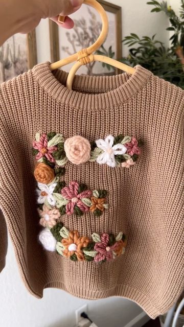 Emma and Sam on Instagram: "Embroidered floral E for Emma 🌸" Embroidery Sweater Diy, Crochet Sweater Design, Knit Machine, Mode Crochet, Embroidery Sweater, Aesthetic Crochet, Unique Sweaters, Embroidered Name, Hand Embroidery Projects