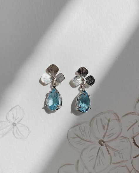 New new. Blue Hydrangea earrings inspired by the flowers in my garden. Sterling silver earrings featuring hand made hydrangea flowers with Swiss blue topaz tear drops. Post and butterfly style findings. Online now 🩵 . . . . . . . . . . . . . . . . #hannahcrossjewellery #jewellery #jewelry #earrings #silver #silverearrings #topaz #blue #bluetopaz #bluehydrangea #hydrangea #flower #flowers #inspiredbynature #handmade #bespoke #nz #nzjeweller #jotd #potd #instagood #love #lovemyjob Hydrangea Earrings, Butterfly Style, Tear Drops, Hydrangea Flowers, Hydrangea Flower, Blue Hydrangea, Swiss Blue Topaz, Cross Jewelry, My Garden