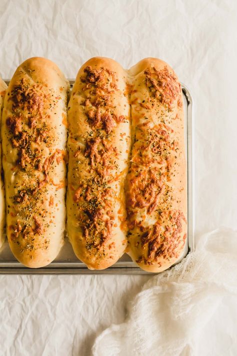 Subway Italian Herb and Cheese Bread lined up on top of a baking tray. Italian Herb And Cheese Bread, Italian Herbs And Cheese Bread, Herb And Cheese Bread, Bread Line, Homemade Bread Dough, Cheese Bread Sticks, Sugar Bread, Italian Herbs, How To Store Bread