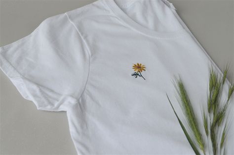 Summer T-shirt with a trendy small embroidery. Little daisy on a white cotton tee. Flower embroidery is 1 inches high. Sizes available:  S    M    L     XL   2XL 6    8     10   12   14 S (40cm-64cm) M (43cm-67cm) L (47cm-69cm) XL (50cm-71cm) 2XL (56m-72cm) PLEASE CHECK YOUR MEASUREMENTS BEFORE PURCHASING AS SIZES VARY BETWEEN COUNTRIES! Fabric:  100% Cotton* Belcoro® yarn  Neatly packaged for an easy gift idea Processing time is one week. Delivery within UK takes 2-3 days. Delivery within Europ Easy Gift Idea, Small Embroidery, Yellow Daisy, Summer Tee, Flower Embroidery, Tees For Women, Easy Gifts, Women T Shirt, Summer Tshirts