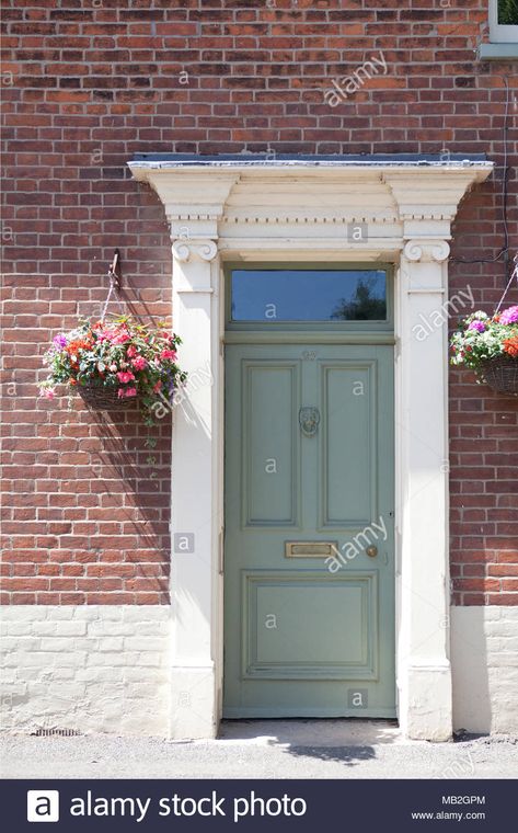 A green painted doorway in a red brick house Stock Photo - Alamy Coral Door Brick House, Painted Front Door Red Brick House, Red Brick House Colored Door, Red Brick Rambler Exterior, Red Brick Green Shutters, Red Brick Ranch Curb Appeal, Door And Shutter Color Combinations Brick House, Green Door Red Brick House, Green Front Door Red Brick House