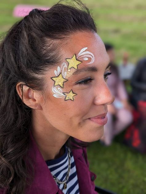 New Year’s Eve Face Paint, Space Themed Face Painting, Stars Face Paint, New Years Face Paint, Uv Face Paint Ideas Simple, Taylor Swift Face Paint, Star Face Paint, Uv Face Paint, Glitter Face Paint