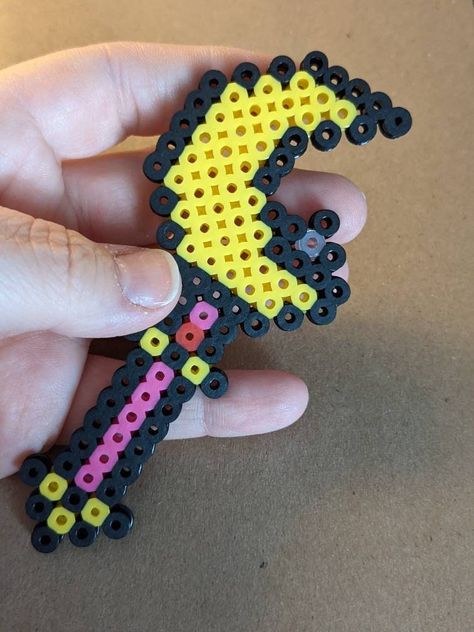 Never run from a real fight again with this Moon Wand inspired magnet OR keychain!  Approximately 11 centimetres (4 and 1/2 inches) in length. This item was handmade by me, using Perler beads. The beads are melted by being ironed together and due to the melting nature, may not be completely solid. Please be careful when handling! I do my best to make sure all beads are properly fused together, however it is always best to practice caution.  Each item is made separately, therefore not all items w Kawaii Fuse Bead Patterns, Perler Bead Bookmarks, Perler Keychain, Melted Beads, Ironing Beads, Perler Bead Designs, Melt Beads, Melt Beads Patterns, Perler Projects