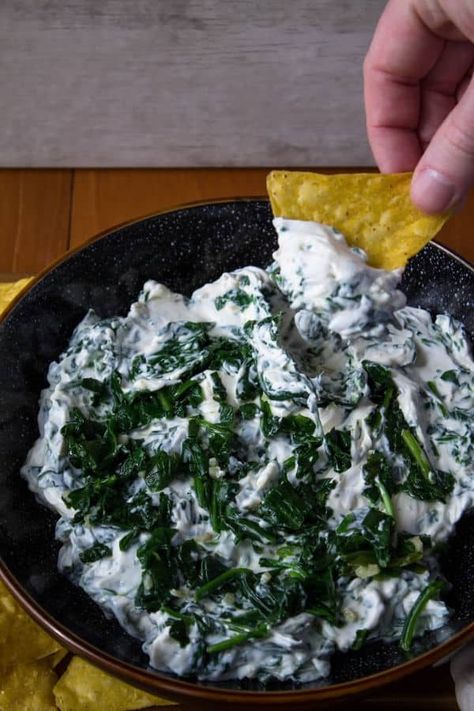 This Creamy Garlic Spinach Dip is great for a gathering, even if it's just amongst your household. We're sneaking in some leafy greens with plenty of cream cheese and garlic. Serve with crunchy tortilla chips or raw veggies for an awesome sharable dip. #spinachdiprecipe #diprecipe #partyfood #appetizerrecipe Raw Veggies, Chili Cheese Dips, Spinach Dip Recipe, Bacon Dip, Garlic Spinach, Meatless Recipes, Easy Chili, Chili Cheese, Cheesy Recipes