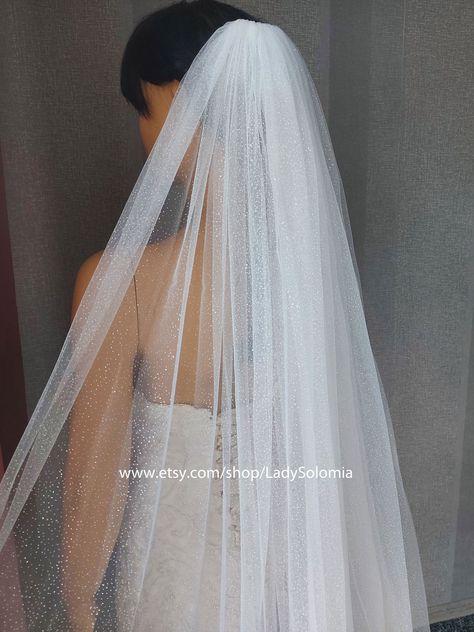 "A Sparkle wedding veil. Elegant and simply delightful. There is a comb at the top of the veil to secure it on the head. On the photo length a veil 108\". This veil is available in a variety of lengths. I can make custom veil for you with length and width that you specify from the style you like. This veil is available in white and ivory. If you have any questions please send me a message, I will be happy to discuss details. Width 120 \" (300cm) 16\" Shoulder length (40 cm) 24\" Elbow length (60 Veil Sparkle, Glitter Veil, Tea Length Formal Dresses, Bachelorette Party Veils, Short Veils Bridal, Veil Simple, Sparkle Veil, Dress Storage, Party Veil