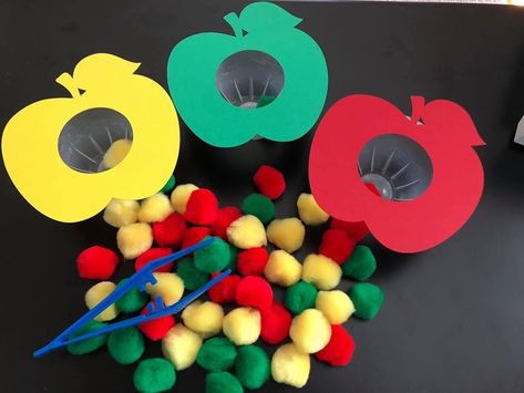 Preschool sorting activity using old applesauce containers, apple cutouts and Pom Pom balls. Fine motor skills Apple Motor Activities Preschool, Apple Activities Toddlers, Apple Ideas For Preschool, Apple Activity For Preschool, Apple Sorting Preschool, Apple Preschool Fine Motor, Apple Fine Motor, Vegetables Crafts For Kids Preschool, Fine Motor Apple Activities For Toddlers