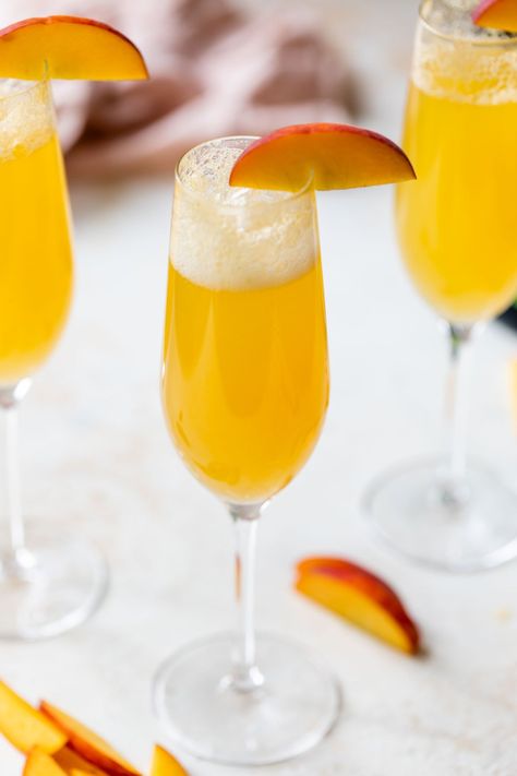 Add some sparkle to your party with a classic peach Bellini! Fizzy, fruity and flavored with peach puree, it's easy to make and always a hit. Bellini Cocktail Recipes, Peach Bellini Recipe, Peach Bellini Cocktail, Red Sangria Recipes, Apple Cider Mimosa, Bellini Cocktail, Well Plated, Bellini Recipe, Lemon Cheesecake Bars