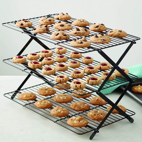 A foldable three-tier cooling rack, so you can finally go hog wild with cookie-baking without taking up your whole kitchen in the process. Reviewers love this space-saving little wonder — it's not only helped rekindle their love of baking, but also helps keep their counter space free for other tasks. Boutique Patisserie, Cooling Racks, Cooling Rack, Baking Essentials, Fun Cookies, Baking Supplies, Taste Of Home, Food Hacks, Baked Goods