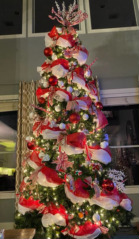 This is my Christmas tree decorated in red and white decor or candycane decor. I collected various ribbons and bunched them where I swooped the mesh. #christmastree #christmas #candycanetree #candycane #redandwhitetree #howtodecorateatree #howtodecorateachrostmastree #christmasdecor #christmasmesh #mesh #ribbon #christmasribbon Red And White Ribbon Christmas Tree, Christmas Tree With Mesh Ribbon, Christmas Tree Mesh Ribbon, Christmas Tree Decor Red, Christmas Tree Red And White, Red And White Decor, Unfurnished Apartment, White Christmas Tree Decor, Christmas Tree Candy Cane