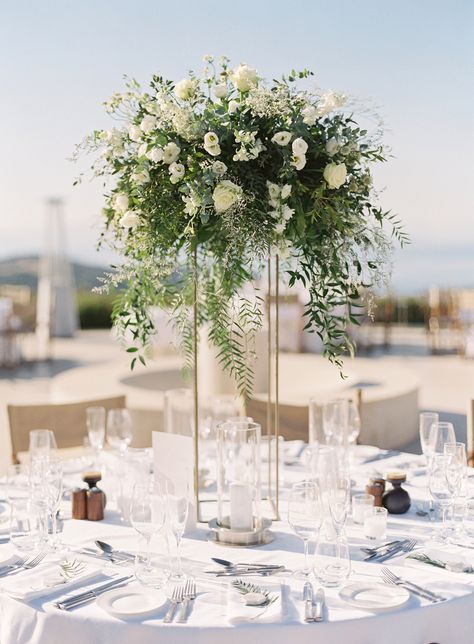 Tall centerpieces by Studio7 towered over the tables. The transparent vases showcased white roses, white lisianthus, and greenery. Pretty Wedding Centerpieces, Beautiful Wedding Centerpiece, Simple Wedding Flowers, Rustic Wedding Decorations, Tall Wedding Centerpieces, Reception Inspiration, Wedding Floral Centerpieces, Tall Centerpieces, Keys Wedding