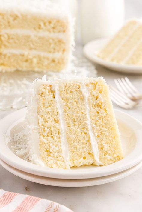 This gorgeous coconut cake is soft, rich, and tender bursting with sweet coconut flavor. The fluffy cream cheese frosting and shredded coconut complete this cake for the perfect bite every time. Dairy Free Cream Cheese Frosting, Vegan Coconut Cake, Moist White Cake, Fluffy Cream Cheese Frosting, Coconut Buttercream, Cake With Coconut, Coconut Cake Recipe, Coconut Frosting, Vegan Coconut