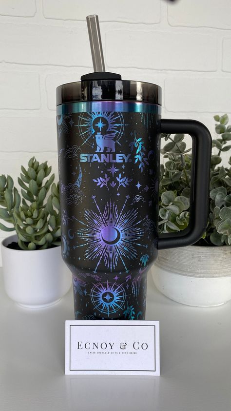 Laser Engraved Stanley 40oz tumbler - BNWT This is a BNWT wrap/seamless Celestial Dreams design- engraved Stanley 40 oz Tumbler with handle and straw lid.  The manufacturer recommends to hand wash all their tumblers including lids and straws.  Color shown in photos and video: Black Chroma These are made to order and there are several colors available.  If you are unsure of a color - please research what each color looks like prior to ordering (A quick google search with the colors listed should do it).  I do my best to reflect the actual color with pictures taken in natural light but people see colors differently and computer monitors have different settings.  *Important note:  We do not take returns for lids that don't line up in a particular direction or any other preference. Warranty cl Tumbler Pictures Ideas, 40 Oz Tumbler With Handle Ideas, Stanley Cup Engraving Ideas, Constellation Tumbler, Cup Engraving, Stanley 40oz Tumbler, Iced Coffee Protein Shake Recipe, Iced Coffee Protein Shake, 40 Oz Tumbler With Handle