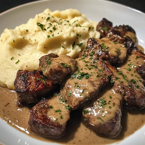 🧄🥩 Garlic Butter Steak Bites and Creamy Mash 🧄🥔 Ingredients For the Garlic Butter Steak Bites: 1 lb sirloin steak (or your preferred cut), cut into bite-sized cubes 🥩 Salt and pepper to taste 🧂 2 tbsp olive oil 🫒 4 tbsp butter 🧈 5 cloves garlic, minced 🧄 1 tsp dried thyme 🌿 1 tsp dried rosemary 🌿 Fresh parsley, chopped (for garnish) 🌱 For the Creamy Mash: 4 large russet potatoes, peeled and cubed 🥔 1/2 cup heavy cream 🥛 1/4 cup butter 🧈 Salt and pepper to taste 🧂 1/4 cup grated Parmesan chees... Food With Beef, Garlic Butter Steak Bites, Butter Steak Bites, Dried Rosemary, Creamy Mash, Butter Steak, Garlic Butter Steak, Sirloin Steak, Dried Thyme