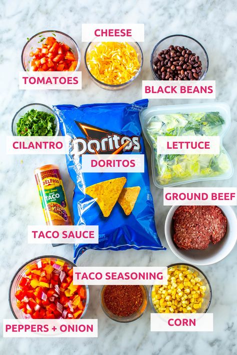 This Dorito Taco Salad is a fun 20-minute dinner idea made with crunchy Cool Ranch Doritos, fresh veggies, cheese and taco sauce. Dorito Taco Salad, Cool Ranch Doritos, Dorito Taco, Taco Salad Doritos, Doritos Taco, Taco Salad Recipe, Sauteed Peppers And Onions, Beef Sauce, Taco Salad Recipes