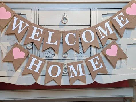 Make your loved ones return home extra special with a welcome home message bunting banner sign. For example; Welcome home to the newlyweds back from their honeymoon, arrival of a new born baby, return from the army, children returning from abroad or school, someone has been discharged from hospital and so on. This bunting comes in white lettering and a pink heart (any colours) at each end. Please remember to write when you need to receive the bunting in 'Note to Seller' box at check out! Details Well Come Decoration Ideas, Decoration For Welcome Home, Welcoming Home Decor, Newborn Decoration Welcome, Welcome Ideas Decoration At Home, Diy Welcome Home Banner, Welcome Home Diy Ideas, Welcome Home Newborn Decoration Ideas, Welcome Back Decorations Home