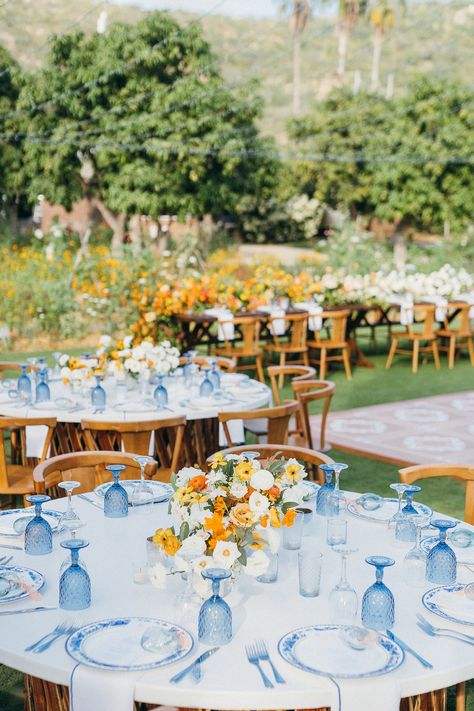 A custom jean jacket for the bride, lush pop of orange florals, a chic something blue wedding design, and dreamy views of the Mexican countryside came together perfectly for Maggie & Jeremy's I-DOs at Flora Farms in San Jose Del Cabo. We love how Amy Abbott Weddings & Events, Gideon Photography, and Pina Hernandez brought the day together. August Themed Wedding, Spaniard Wedding Theme, Blue Yellow And Orange Wedding, Light Yellow And Light Blue Wedding, Yellow And Blue Themed Wedding, Blue Coastal Wedding Theme, Yellow Aesthetic Wedding, Blue And Orange Wedding Decor, Nantucket Wedding Aesthetic