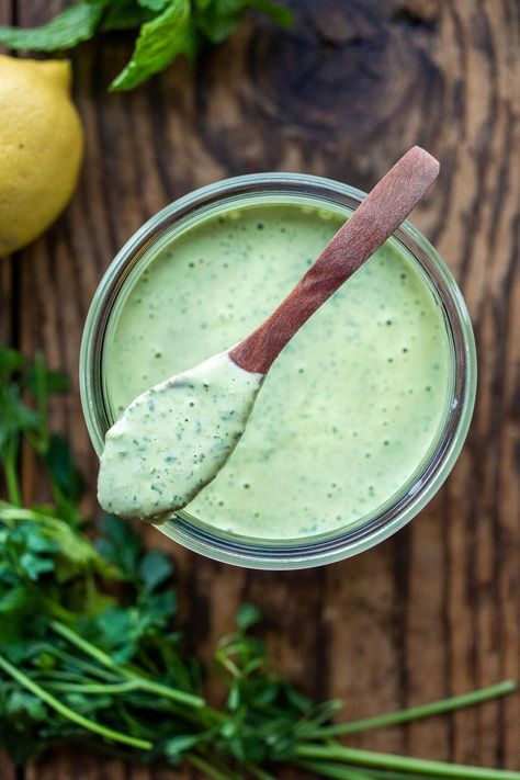 Flavorful Green Tahini Sauce made with tahini paste, fresh herbs, garlic, lemon and a few slices of green chilies. Perfect vegan condiment to serve with falafels, pita bread, shawarma, mezze platters! #tahinisauce #tahini #vegan Creamy Avocado Ranch Dressing, Goddess Dressing Recipe, Green Goddess Salad Dressing, Avocado Ranch Dressing, Plats Healthy, Goddess Dressing, Avocado Ranch, Whole Roasted Cauliflower, Green Goddess Dressing