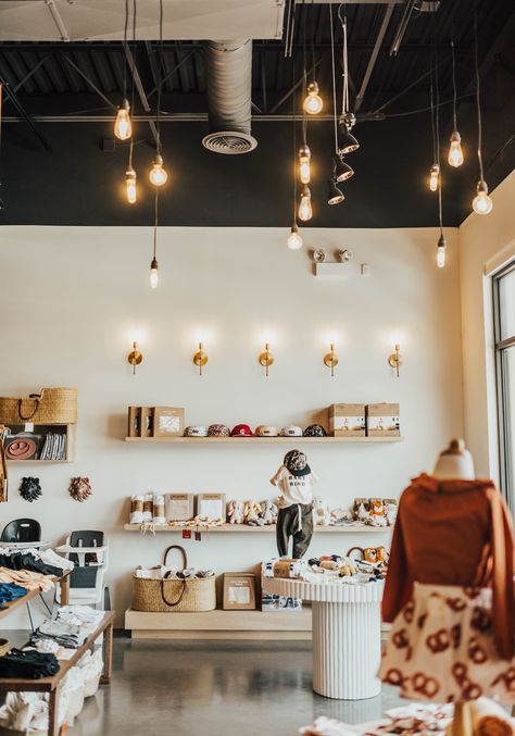 Exposed ceiling with modern lighting. Exposed Lighting, Baby Store Display, Exposed Ceiling, Exposed Ceilings, Retail Store Interior Design, Retail Lighting, Retail Interior Design, Store Design Boutique, Retail Store Interior