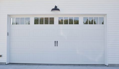 A gooseneck barn light adds classic style above the garage door! White Garage Door With Windows, Above Garage Door Lighting, Light Above Garage Door, Long Panel Garage Door, Modern Farmhouse Inspiration, Garage Lights Exterior, Cedar Garage Door, Garage Door Lights, White Garage Doors