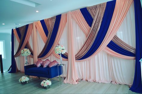 Navy blue, peach, blush backdrop  #decor #wedding #diywedding #diyweddingdecor #diyweddingideas #weddingdesign #diy #diywedding #weddingdecor #weddingdecorations #weddingdecorationideas #dollartreediy #weddingplanning #silkflowers #floraldesign #fabricwholesaledirect #luxurywedding #weddingday #weddingceremony #mehndidecorations #mehndi #floralframe #weddinginspiration #weddinginsta #weddinginstagram #idea #backdrop #mandap #flowerwall  #flowerarch #canopy Draping Decor Backdrop Ideas, Navy Blue And Gold Backdrop, Peach And Navy Blue Wedding, Navy Blue And Blush Pink Wedding Backdrop, Rose Gold Curtains, Royal Blue Curtains, Reception Stage Decor, Wedding Reception Backdrop, Curtain Backdrops