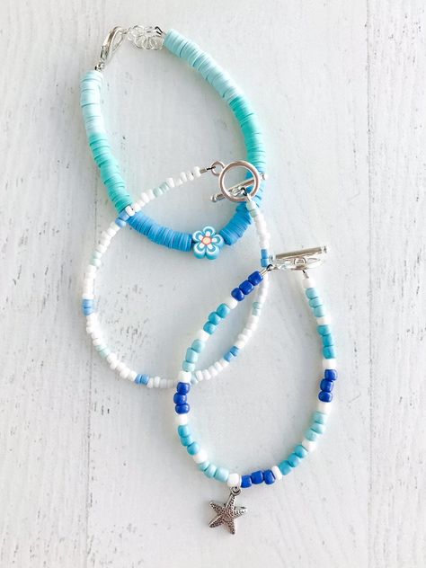 These bracelets come as a set of 3 beachy theme bracelets perfect for a beach day! Made to fit an average adult wrist. Please message me directly for a sizing adjustment (ex. smaller or larger than average) Coastal Bracelet Ideas, Beachy Crochet Ideas, Beaded Beach Bracelets, Ocean Bracelet Ideas, Beachy Bracelet Ideas, Beach Bracelets Clay Beads, Beachy Clay Bead Bracelet, Bracelet Themes, Beach Themed Bracelet