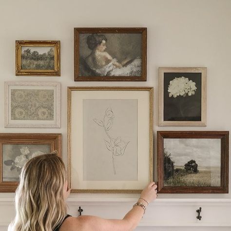 Liz Fourez | Love Grows Wild on Instagram: "Who’s been here long enough to remember the vintage gallery wall in my master bedroom? 👋🏻  Well, because that room is now becoming my teenage son’s bedroom, he wanted the floral, girly art prints removed from his wall immediately (I can’t imagine why 🙃). All those gorgeous frames I so carefully curated have just been sitting in a pile on the floor, but the other day I came up with a plan to re-purpose them in my new office…  So much charm and character added to this big blank white wall! On lovegrowswild.com today, I’m sharing how I designed this gallery wall, plus —  • tips for sourcing vintage style frames  • easy ways to curate multiple pieces of art for a cohesive look • where I like to print digital artwork • 2 ways to create a gallery wa Gallery Wall Transitional, Amazon Gallery Wall, Artistic Gallery Wall, Picture Above Bed, Liz Fourez, Corner Gallery Wall, Bedroom Gallery Wall, Wall Layout, Vintage Gallery Wall