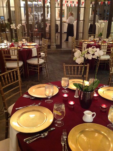 Burgundy linens, gold chargers, gold chivari chairs with ivory pads, simple orchid centerpieces, votive candles Gold Chivari Chairs, Chivari Chairs, Popular Wedding Colors, Orchid Centerpieces, Decoration Evenementielle, Gold Chargers, Color Vino, Gold Centerpieces, Marsala Wedding