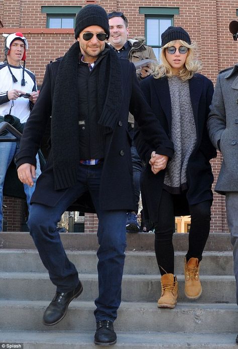 Bradley Cooper. Always carefully styled. Note the black Red Wing Iron Ranger boots that anchor the look and play nicely with the black wool coat, the black puffer vest, the black stocking cap and classic aviator sunglasses. Peeking out from under the black layers is a colorful blue, white and red plaid shirt that echoes the color of the blue jeans. Note the texture on the scarf and the hat. This simple, casual look is beautifully crafted. Redwing Iron Ranger Outfits, Iron Ranger Boots Outfit, Iron Ranger Outfit, Iron Ranger Boots, Red Wing Style, Ranger Boots, Red Wing Iron Ranger, Black Stocking, Iron Ranger