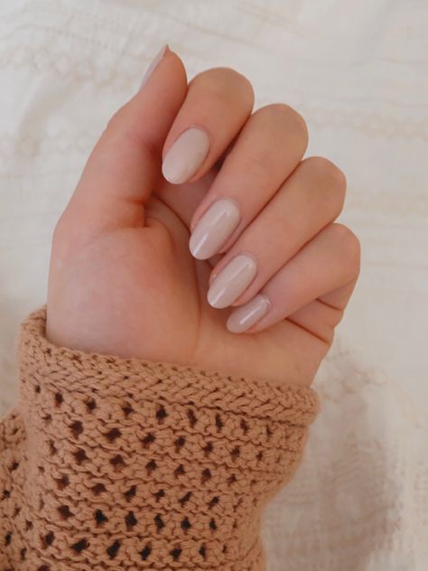 A picture of a creamy white gel polish with subtle pink and purple undertones on almond-shaped natural nails. The subject is wearing a peachy-tan colored crochet sweater which can be seen on their wrist. Engagement Nails Almond, Nails Almond Shape, Engagement Nails, Shaped Nails, Nails Fashion, Neutral Minimalist, Almond Shape, Nails Almond, Almond Shaped