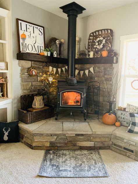 #woodstove #homedecor #cornermantle #farmhouse #fall #falldecor #mountains Raised Woodstoves, Woodstove Mantle Decor, Wood Stove Area Ideas, Wood Burning Stove Corner Farmhouse, River Rock Wood Stove Surround, Farmhouse Wood Stove Hearth, Wood Stove Hearth Ideas Farmhouse, Pellet Stove Hearth Ideas, Wood Stove Mantle