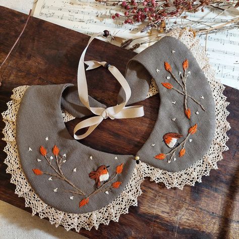 Handcrafted linen collar, mink-coloured ornate collar with robin bird hand-embroidered artistic and earth-toned flowers.  I hand-embroidered this unique bohemian clothing accessory with a cute robin bird and orange flowers inspired by nature, with 100% cotton threads.  This stylish collar is extremely durable, wear-resistant and long-lasting thanks to its high-quality fabric. It has a standard size and you can easily adjust it to fit your neck thanks to its tie at the back.  This will be the perfect and most amazing gift for your friends and family. Thanks to its dreamy, classic design, you or your loved ones can wear it daily or on special occasions! I handcraft all of my products in my workshop using only high-quality & recyclable materials. All of my products eco-friendly because I supp Embroidered Collars Embroidery, Spring Embroidered Blouse With Peter Pan Collar, Cotton Cottagecore Top With Peter Pan Collar, Cute Collars, Embroidered Peter Pan Collar, Color Vison, Bohemian Wear, Mink Colour, Sewing Collars