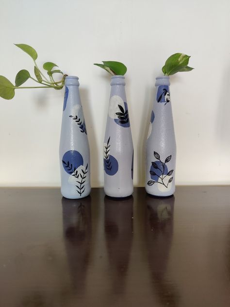 A set of three hand-painted bottles perfect for gifting and home decor Boho Bottle Painting, Boho Art On Bottle, Bottle Hanging Decor, Aesthetic Bottle Painting, Aesthetic Bottle, Bottle Paintings, Bottle Designs, Easy Room Decor, Painted Bottles