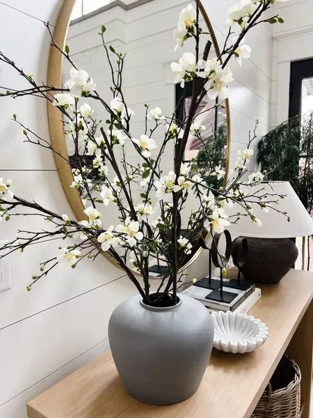 Spring console table styling! Afloral is have a Sitewide sale this weekend! Save 20% off orders of $100+ with code BRANCHES through 4/23! These exact branches are sold out but I linked a similar as well as the gorgeous vase that they are in! Home decor refresh, florals How To Style A Console Table, Clay Table, Fake Flower Arrangements, Entryway Style, Console Table Styling, Entry Ways, Jug Vase, Table Vase, Spring Home Decor