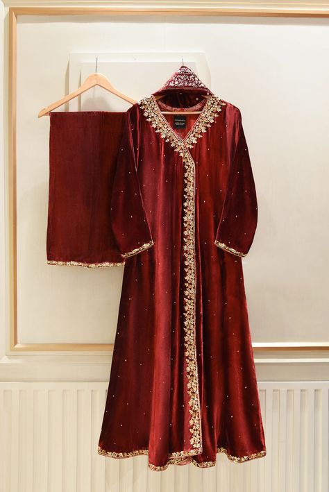 A heavily embellished beautiful three piece on pure dark maroon velvet, adorned with the most stunning hand/ada work of dabka, naqshi, sequins and crystals done by our skilled artisans. Paired with a heavily embellished pure velvet shawl and flappers featuring matching border. The length of the long angrakha is 48 inch Agha Noor Bridal, Bridal Shirts, Velvet Dress Designs, Pakistani Party Wear, Velvet Shawl, Kurta Style, Dark Maroon, Pakistani Fancy Dresses, Pakistani Fashion Party Wear