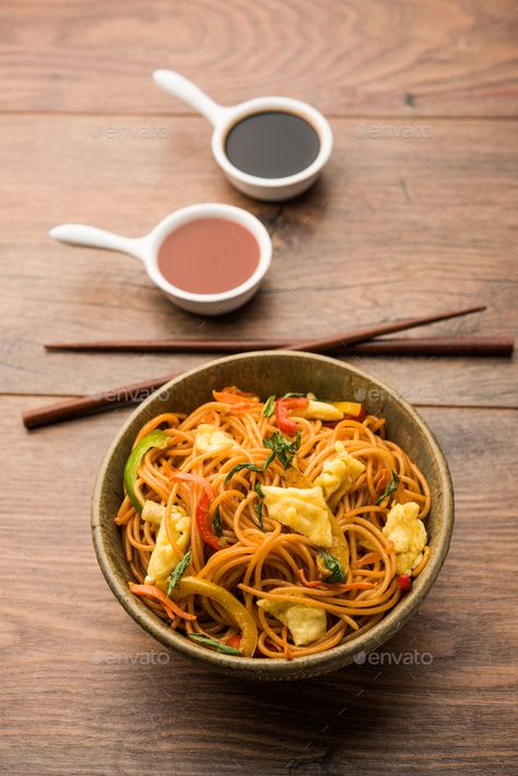 Egg Hakka Noodles by stockimagefactory. Egg Schezwan noodles / hakka noodles, popular indochinese food served in a bowl with chopsticks #Sponsored #stockimagefactory, #Schezwan, #noodles, #Egg Schezwan Noodles, Indo Chinese Recipes, Hakka Noodles, Chopsticks, Pad Thai, A Bowl, Japchae, Cooking And Baking, Design Illustration