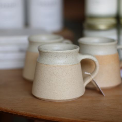 Bring unique style to your happy morning routine with this handmade ceramic mug of simple earth colors. This artfully handcrafted mug features a unique white interior glaze and unfinished stoneware exterior. Perfectly shaped to fit in the palms of your hands, this small-batch artisanal mug is highly versatile for use with your tea or espresso. Size and color may vary due to the handmade nature of the product. Size - 3" h, holds 8 fl oz. Some variation in the body of the mug may be present due to the handmade and firing process in the artisanal process. F ood safe, lead-free, microwave, dishwasher, and oven safe This eco-friendly product manufacturing has given the village in south India a platform where the villagers could stay back and earn a fair wage instead of migrating to bigger towns Simple Ceramic Mug, Hand Made Mugs, Cool Pottery Ideas, Mug Shapes, Handmade Ceramic Mugs, Product Manufacturing, Earth Colors, Boutique Ideas, Glassware Kitchen