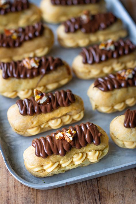 Chocolate eclairs with salted caramel custard and pecan brittle - Salted Caramel Eclairs, Choux Craquelin, Pecan Brittle, Chocolate Eclairs, Caramel Custard, Choux Buns, Eclair Recipe, Gourmet Food Plating, Pretty Desserts