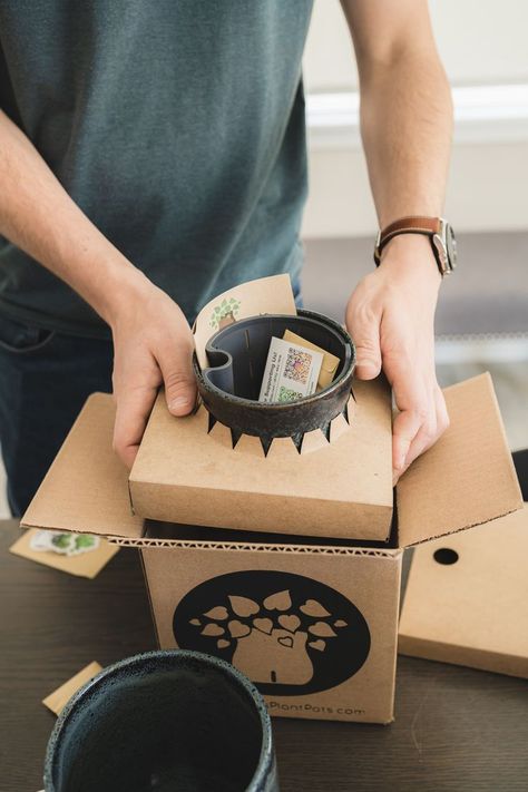 Hands place a ceramic plant pot with a rubber liner into a screen printed cardboard box. The pottery has a chipboard brace around the middle holding it in place. Cup Packaging Ideas, Ceramics Packaging, Pottery Packaging, Pot Packaging, Fragile Packaging, Ceramic Packaging, Packaging Inserts, Unique Packaging Design, Biscuit Packaging