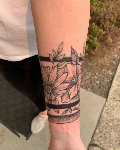 Black Armband Tattoo With Flowers Black Band Flower Tattoo, Black Band Tattoo With Flowers, Black Arm Band Tattoo For Women, Thick Line Tattoos Flower, Solid Arm Band Tattoo, Wrap Around Elbow Tattoos For Women, Black Ring Tattoo, Flower Armband Tattoo, Wrist Cuff Tattoos For Women