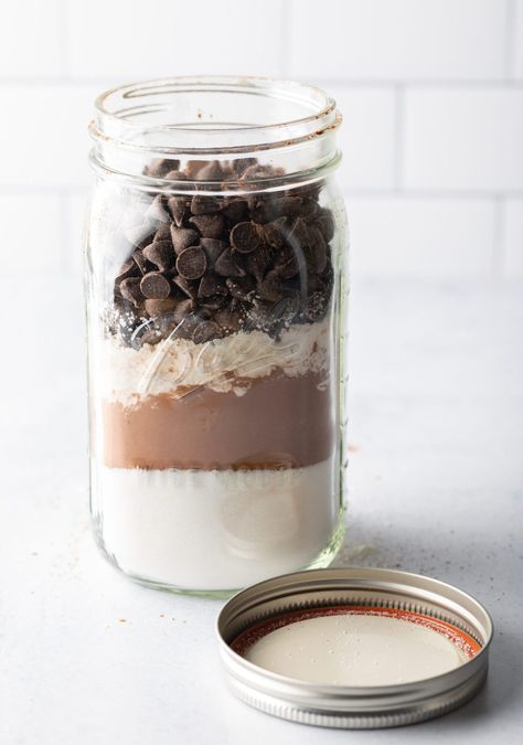 Homemade Ghirardelli brownie mix, dry ingredients layered in a large mason jar with lid off and next to the jar. Brownie Mix Jar, Mason Jar Brownies, Mason Jar Brownie Mix Recipe, Ghirardelli Brownies, Brownie Mix In A Jar, Ghirardelli Brownie Mix, Fudgy Chocolate Brownies, Brownies In A Jar, Brownie Mix Recipes