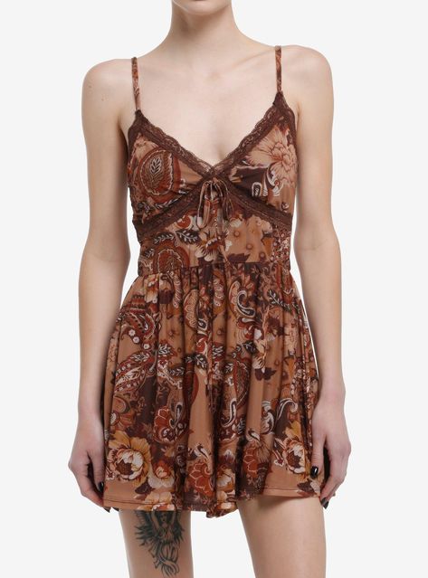 Bring those earth-tones into spring with this refreshing romper! Featuring an allover brown and gold paisley patchwork design  plus lace detailing on the bust. Comes with a front tie and adjustable straps.90% polyester; 10% spandexWash cold; dry lowStretchy materialLength: 31''ImportedListed in junior sizesModel is 5'10''Model wears size Small Patchwork Romper, Brown Floral Print Mini Dress For Summer, Brown Bohemian Mini Dress, Paisley Dress Brown, Spring Brown Mini Dress From Urban Outfitters, Brown Fitted Floral Print Mini Dress, Emily The Strange, Blue Beetle, Lady And The Tramp