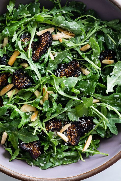 The simplest five-minute arugula salad recipe with figs and toasted almonds. Easy enough for weeknights and festive enough for the holiday table, this back-pocket arugula salad recipe hardly needs a recipe! #recipe #arugula #easy #quick #salad #healthy #glutenfree #figs #driedfigs #figsalad #holiday #almonds #parmesan Arugula And Fig Salad, Christmas Arugula Salad, Arugula Fig Salad, Argula Recipes Salad, Recipe Arugula, Starter Salad, Fig Salad, Arugula Salad Recipes, Spinach Salad Recipes