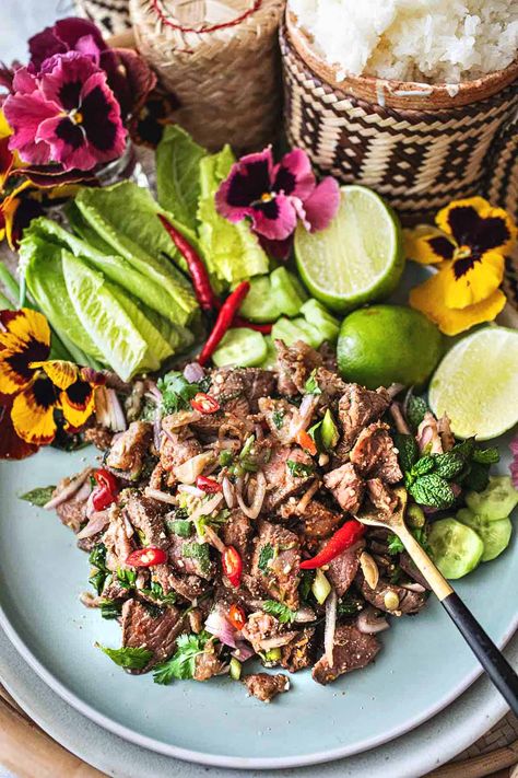 This authentic Thai beef larb recipe is a super tasty and popular dish from Isaan (Northeastern )Thailand. It's a flavorful salad made with near-raw, thinly sliced beef. This tasty Thai larb has a wonderful assortment of fresh herbs that bring out the bold, addictive flavors. It's an easy recipe, and it's extra healthy! #beeflarb #beeflaab #beeflarbrecipe #authenticbeeflarb #thailarb #thailaab #thailaabrecipe #authenticlaabrecipes Beef Larb, Laab Recipe, Thai Larb, Thai Beef Salad Recipe, Larb Recipe, Thai Beef Salad, Steak Dishes, Thai Beef, Tasty Thai