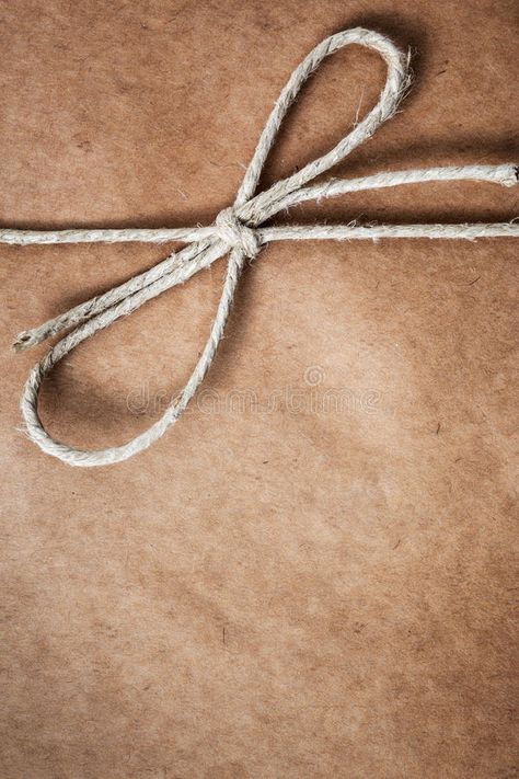 String tied in a bow, over brown package paper. Brown paper gift package backgro #Sponsored , #AD, #paid, #bow, #String, #gift, #brown Photo String, Brown Paper Package, Brown Paper Wrapping, Bow String, Brown Paper Packages, Phone Aesthetic, Homemade Soap Recipes, Graphic Designer Portfolio, Brown Box