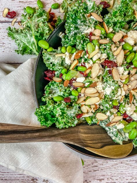 I was inspired by a kale salad from one of the restaurants we visited in Savannah, GA and I instantly knew I wanted to try and recreate it at home. The salad was a delicious combination of kale, dried cranberries, almond slices, steamed edamame, crumbled feta cheese. Hearty kale salad loaded with tons of fresh flavor! Drizzled with a creamy tahini lemon dressing that brings the whole dish together. Kale Edamame Salad, Tahini Kale Salad, Kale Sweet Potato Salad Tahini Dressing, Kale Salad Tahini Dressing, Steamed Edamame, Salad With Edamame, Hillstone Emerald Kale Salad, Raw Treats, Lemon Tahini Dressing