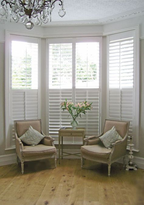 Love that these can be half closed, half opened to reduce glare or give privacy. Bay Window Shutters in Essex Shutters For Bay Window Living Rooms, Shutters Bay Window Living Room, White Shutters Bay Window, Half Shutters Bay Window, Shutters Bay Window, Wooden Shutters Bay Window, Shutters With Curtains, Bay Window Shutters, Bay Window Curtains