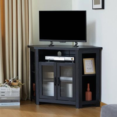 This corner TV stand adds storage to any space in your home. It's crafted from engineered wood and boasts a corner-shaped frame, making it great for compact living rooms and tiny bedrooms. There are four angled cubbies - ideal for books or decorative items. And a centre shelf for media or game consoles, with two power cord management ports on the back to keep the wires clean and hidden.Below the central shelf is a storage cabinet, opening two glass cabinet doors reveals two adjustable height she Small Corner Tv Stand, Corner Entertainment Center, Corner Tv Cabinets, Corner Tv Stands, Media Console Table, Hexagonal Design, Corner Tv Stand, Tv Stand With Storage, Corner Tv