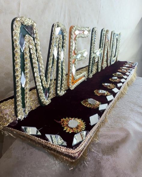 🌿 **Handmade Mehndi Thaal with "Mehndi" Inscription – Perfect for Your Mehndi Ceremony** 🌿 Celebrate your mehndi ceremony in style with our exquisite Handmade Mehndi Thaal, featuring the word "Mehndi" beautifully inscribed on the platter. This handcrafted thaal is designed to be the centerpiece of your mehndi event, combining traditional artistry with modern elegance to create a stunning display. ✨ **Features:** - **Artisan Craftsmanship:** Lovingly handmade with intricate designs, vibrant ... Traditional Mehndi Decoration, Pakistani Wedding Decoration Mehndi, Mehndi Thaal, Mehandi Tray Decoration, Mehndi Plates Ideas Pakistani, Mehndi Ornaments For Bride, Mehndi Night, Mehndi Ceremony, Desi Wedding Decor