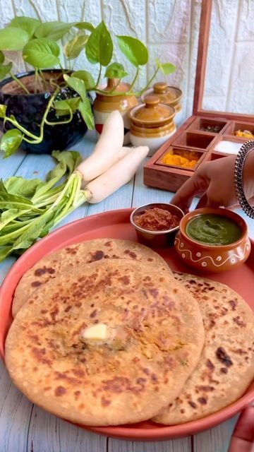 Foodklick on Instagram: "✨ Mooli ke Parathe ✨ Mooli paratha is a popular Punjabi whole wheat flatbread made especially in winters with unleavened dough and filled with spiced grated radish stuffing. They are often made for breakfast or lunch and make for a filling and tasty meal accompanies with pickle, curd (yogurt) or white butter. There are two ways to make this paratha. Either the stuffing is encased between 2 layers of the dough. Or the stuffing is mixed with the flour and kneaded to a do Mooli Paratha, Variety Food, Aloo Paratha, Coriander Powder, Coriander Leaves, Recipes From Heaven, Chilli Powder, Whole Wheat, Flatbread